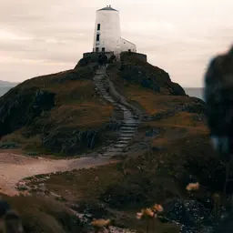 White Lighthouse Atop a Rocky Coastal Hill — Travel jigsaw puzzle